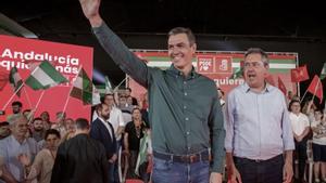 El secretario general del PSOE y presidente del Gobierno, Pedro Sánchez (i), junto al líder del partido en Andalucía y candidato a la Junta, Juan Espadas (d), saludan a los asistentes al mitin de precampaña en Dos Hermanas, Sevilla, este 28 de mayo de 2022.