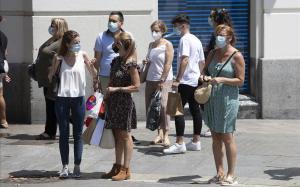 Varios ciudadanos con mascarilla pasean por las calles de Barcelona, este martes. 
