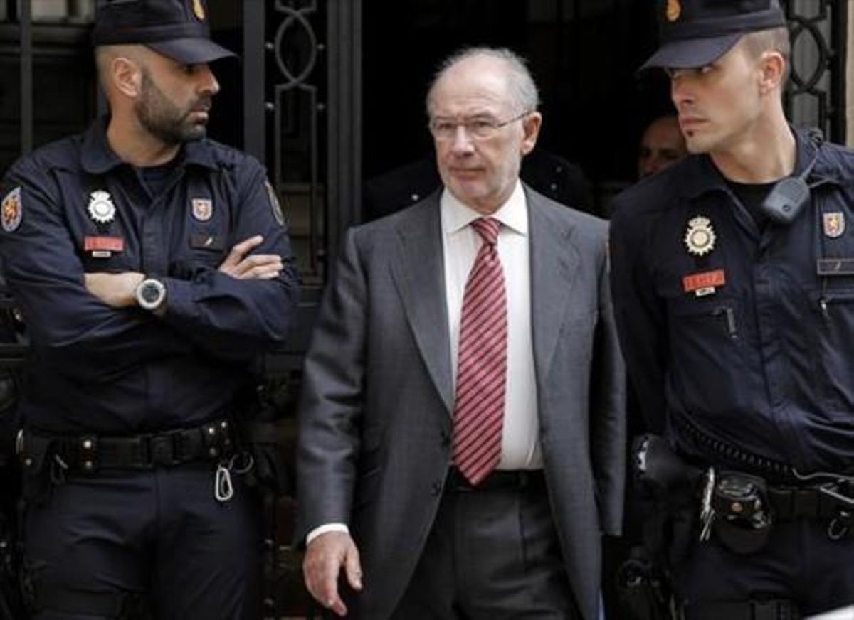 Rato, flanqueado por dos policías tras el registro de su despacho, el pasado 17 de abril. Rato, flanqueado por dos policías tras el registro de su despacho, el pasado 17 de abril.