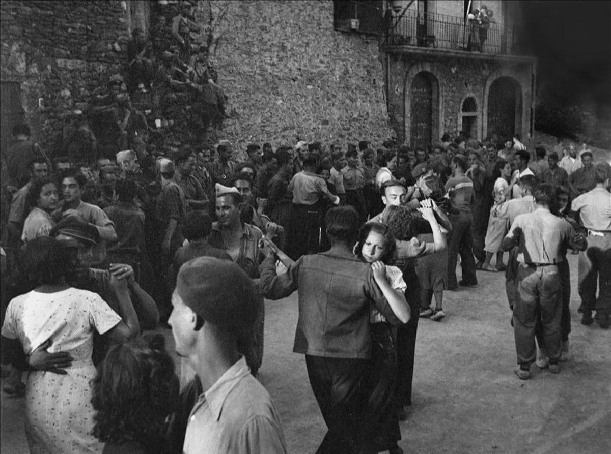 Miembros de la Aliança Nacional de la Dona Jove bailan con los soldados en Santa Maria de Meià.
