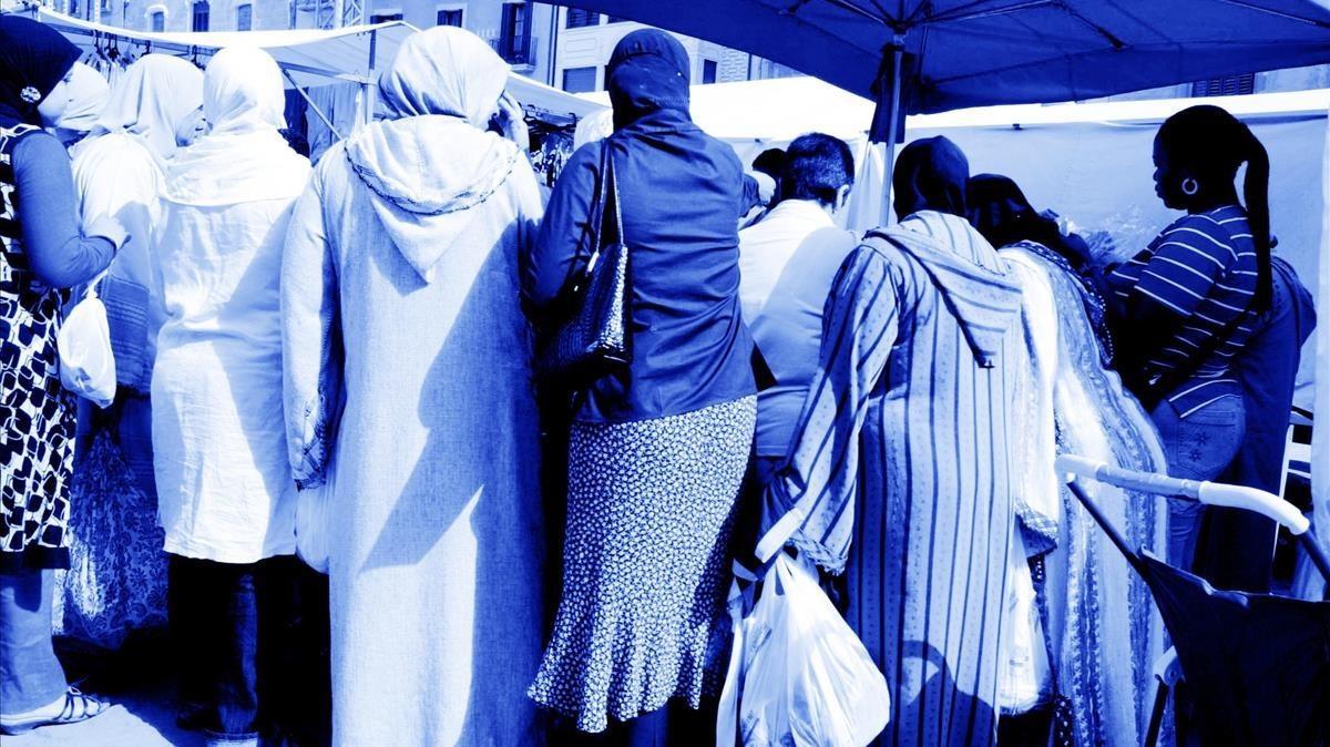 Mujeres comprando en un mercado ambulante.