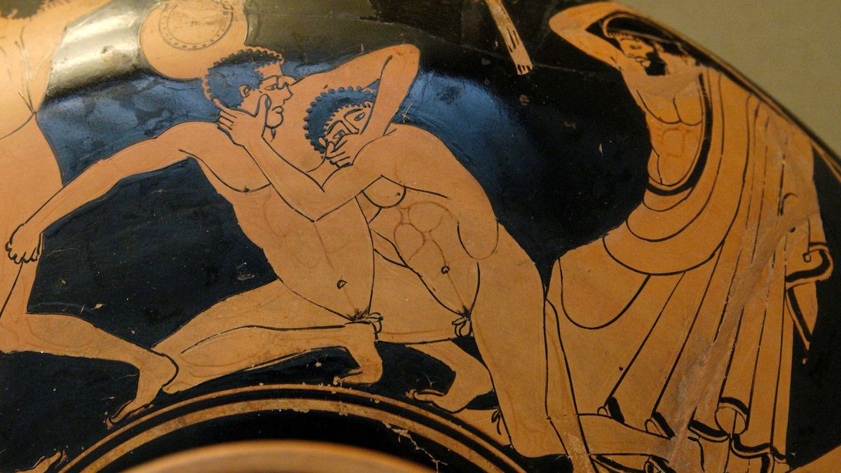 Escena típica de pancraci. Un dels adversaris intenta posar el dit a l’ull a l’altre i el jutge està a punt de fuetejar-lo com a càstig (Col. Museu Britànic) Escena típica de pancraci. Un dels adversaris intenta posar el dit a l’ull a l’altre i el jutge està a punt de fuetejar-lo com a càstig (Col. Museu Britànic)