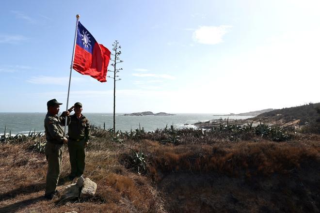 Dos veteranos del Ejército de Taiwán izan la bandera de Taiwán en el puesto miliar de Kinmen el pasado 15 de octubre.