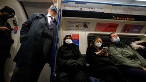 Pasajeros del metro de Londres, con mascarilla, para protegerse del covid.