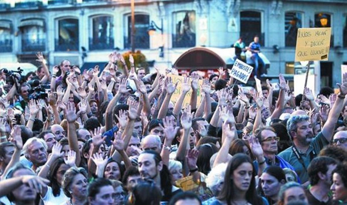 Decenas de personas levantan sus manos durante la manifestación en Madrid.