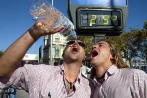 Dos jóvenes beben agua en un día caluroso en Barcelona. EPC