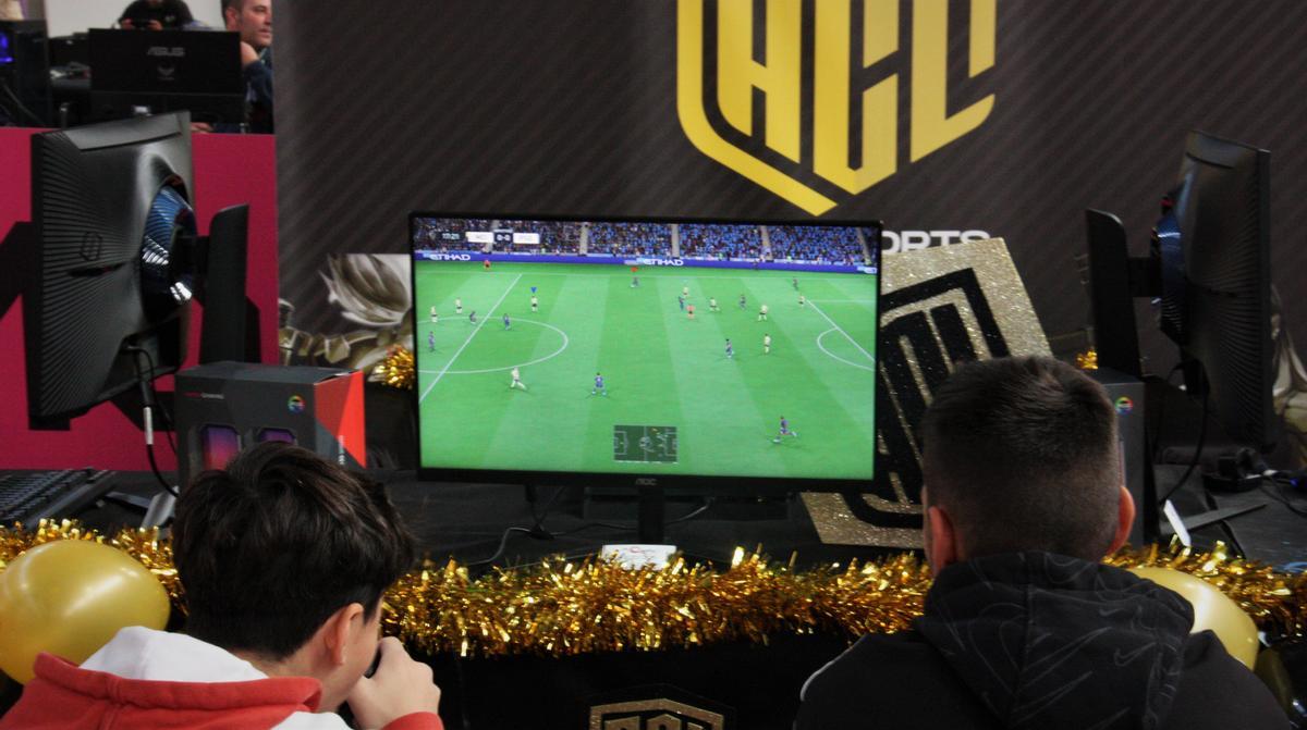 Dos niños juegan en un videojuego de fútbol en el Saló del Gaming (SAGA).
