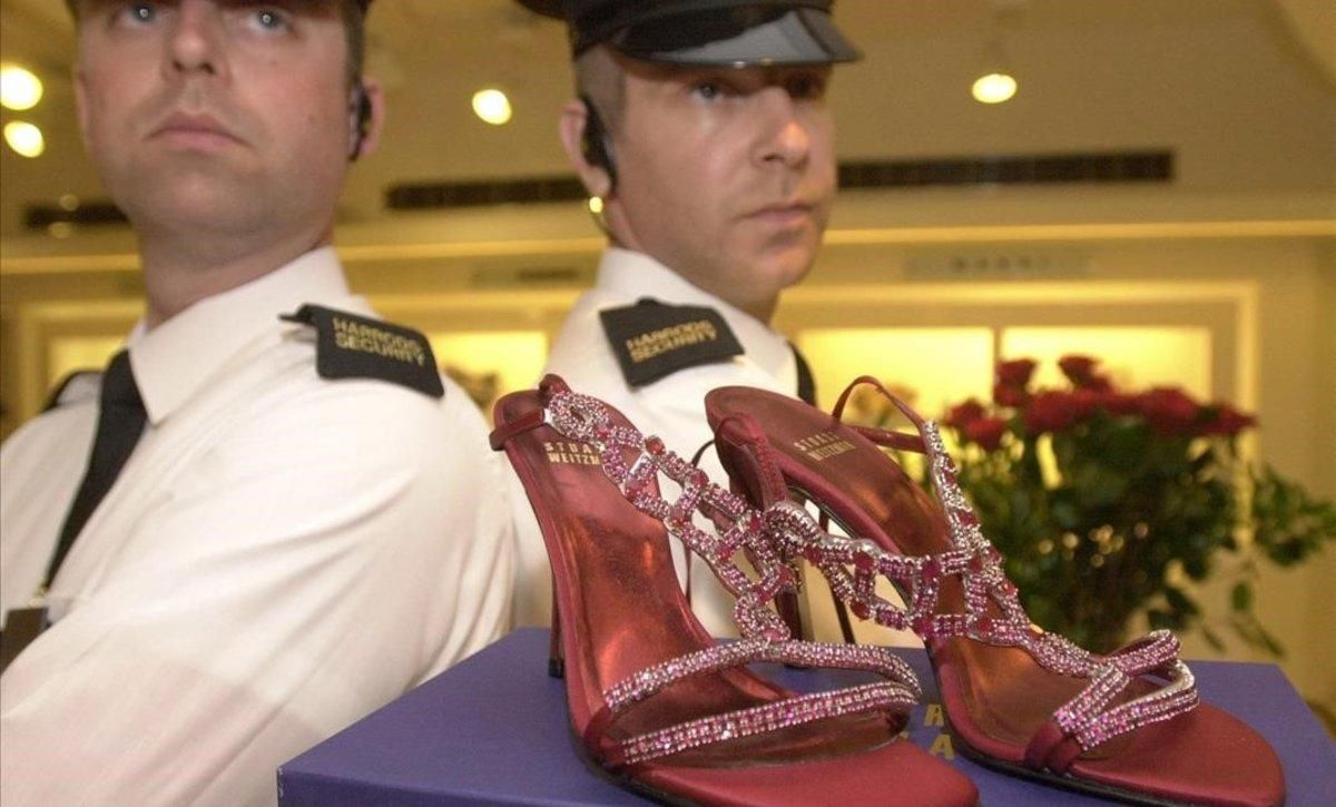 Guardias de seguridad custodian unos zapatos con rubís y platino valorados en 1,47 millones de euros, en Harrods. Guardias de seguridad custodian unos zapatos con rubís y platino valorados en 1,47 millones de euros, en Harrods.