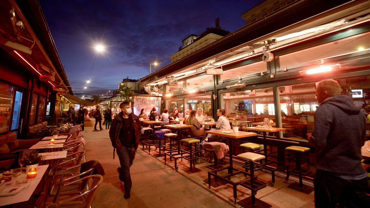 People share time at a cafe bar at Naschmarkt market the evening before the start of the second lockdown amid the coronavirus di People share time at a cafe bar at Naschmarkt market the evening before the start of the second lockdown amid the coronavirus di