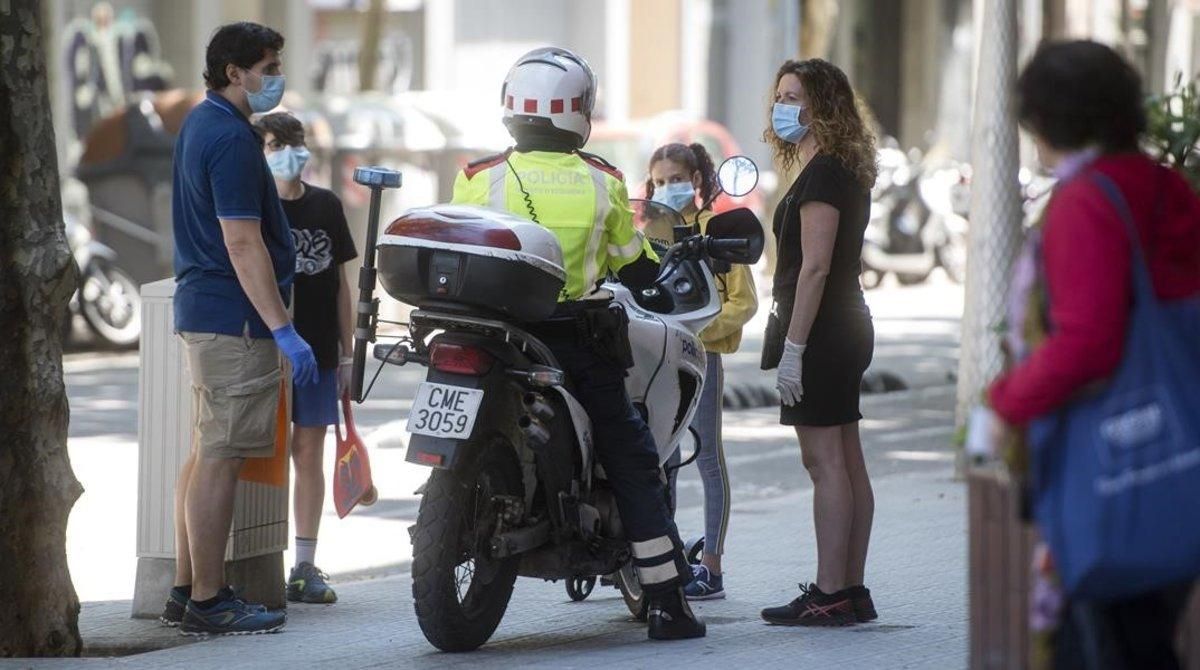 Un mosso le recuerda a una familia que solo puede pasear con un menor con un adulto. Un mosso le recuerda a una familia que solo puede pasear con un menor con un adulto.