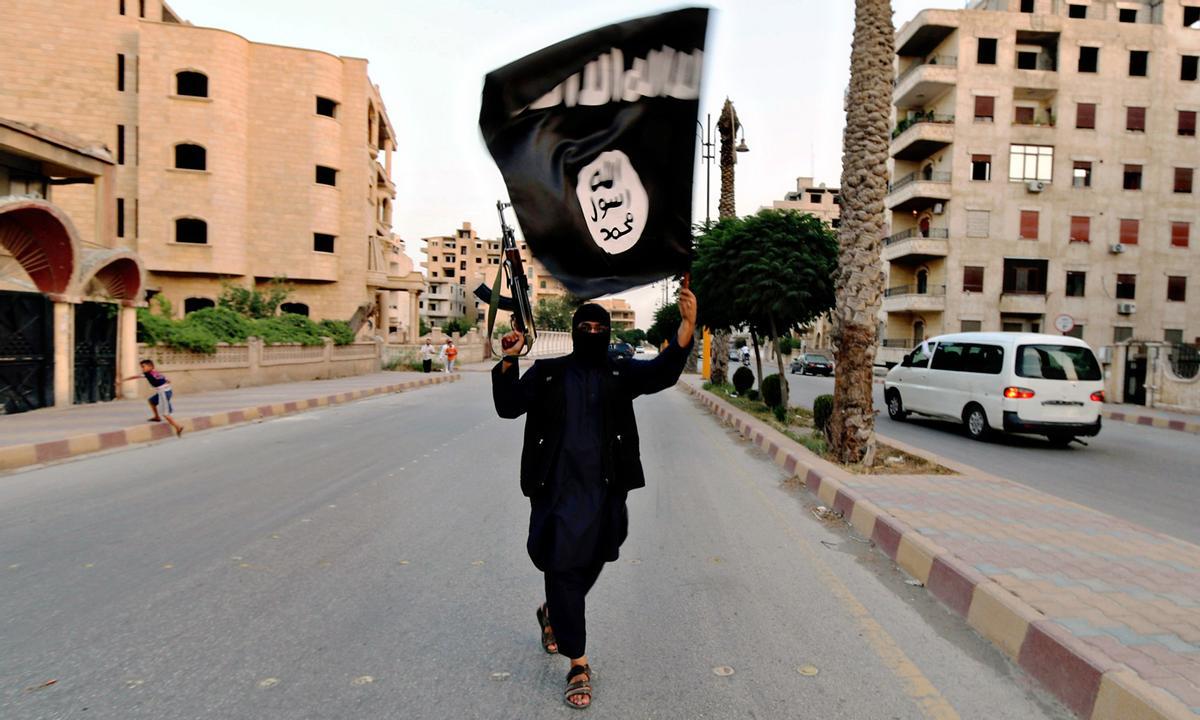Un miembro del Estado Islámico ondea una bandera en Siria. 