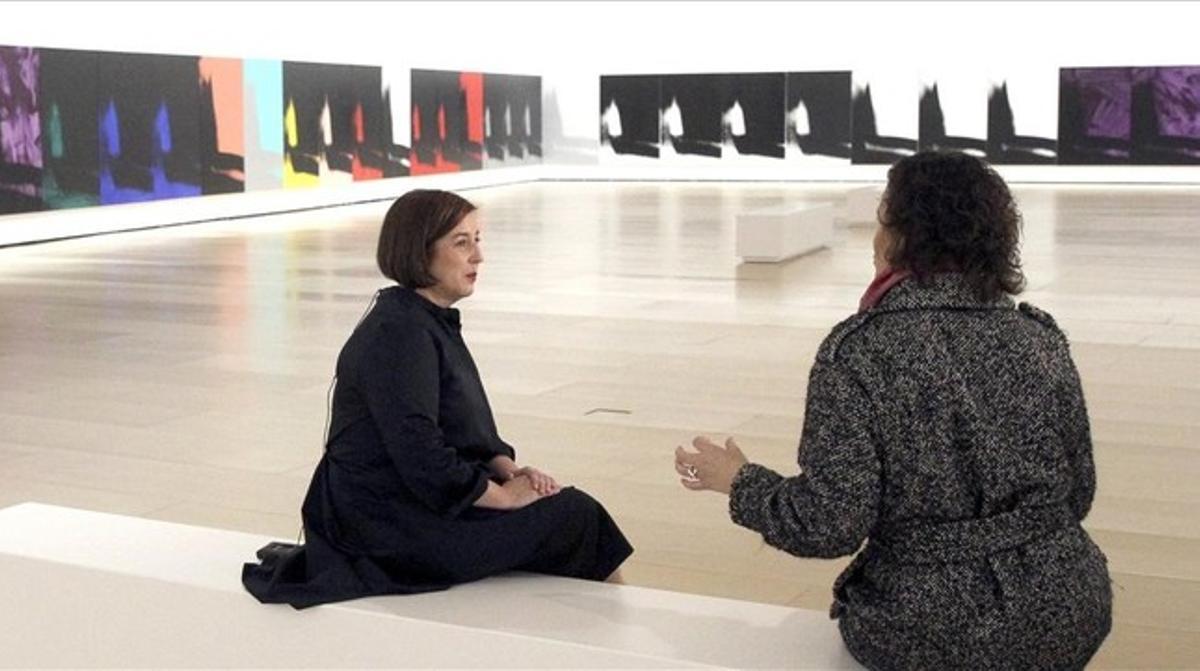 Dos mujeres conversan ante algunos de los 102 lienzos de la monumental ’Sombras’ de Andy Warhol expuesta en el Guggenheim de Bilbao.
