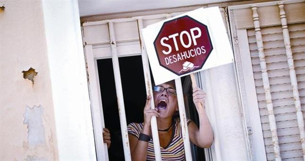 Una mujer protesta desde la ventana de una casa durante un acto de desahucio, en junio del 2011, en Madrid. Una mujer protesta desde la ventana de una casa durante un acto de desahucio, en junio del 2011, en Madrid.