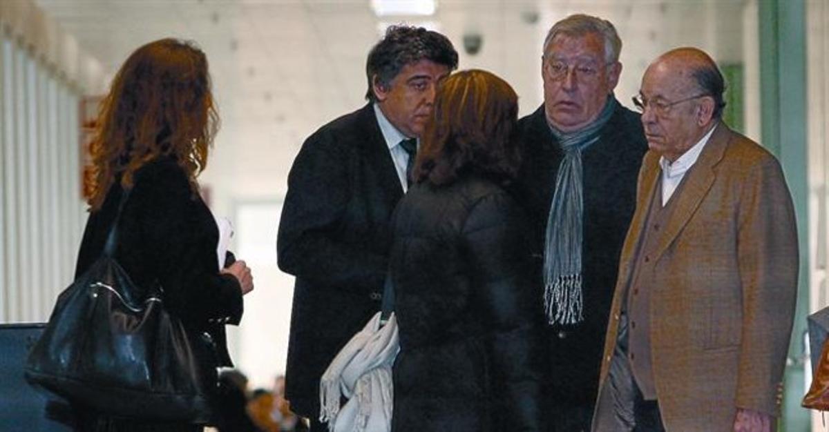 Jordi Montull (con bufanda) y Fèlix Millet (con americana marrón), en compañía de sus abogados, en la Ciutat de la Justícia.