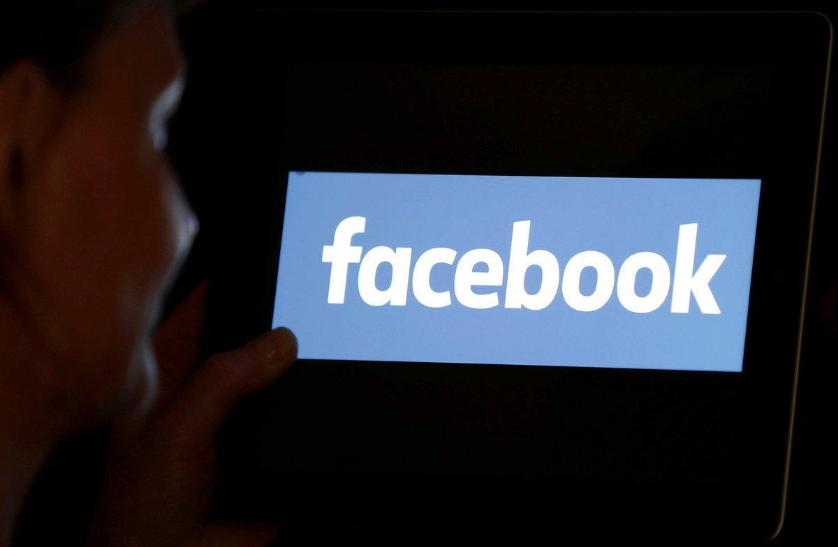 FILE PHOTO  A woman looks at the Facebook logo on an iPad in this photo illustration taken June 3  2018  REUTERS Regis Duvignau Illustration File Photo