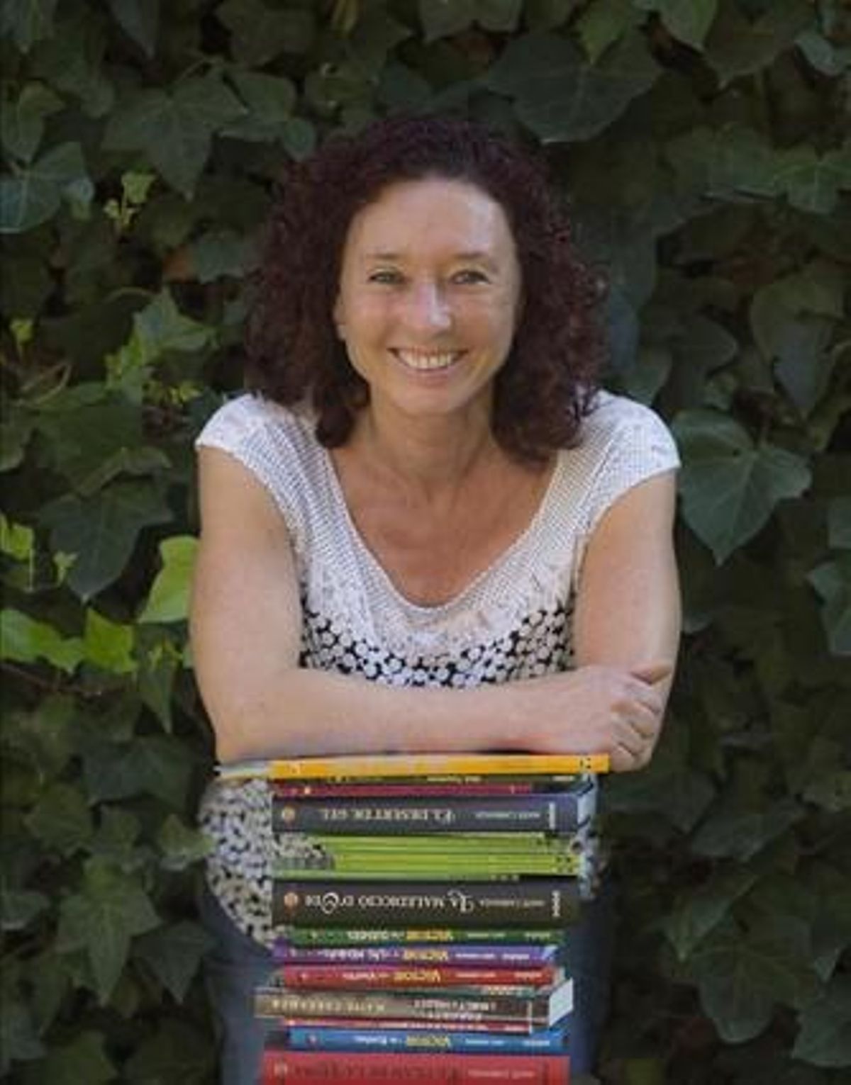 Maite Carranza, en el patio de su casa, apoyada en sus libros, que se han traducido a más de 20 lenguas. Maite Carranza, en el patio de su casa, apoyada en sus libros, que se han traducido a más de 20 lenguas.