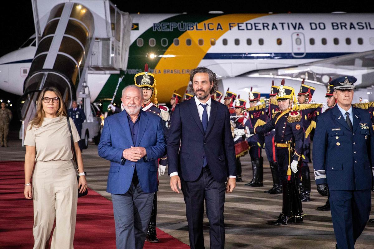 El presidente brasileño Luiz Inacio Lula da Silva (C), acompañado por su esposa Rosangela Janja da Silva (I) y el canciller argentino Santiago Cafiero (D), durante su llegada a la Estación Aérea Militar Aeroparque Jorge Newbery en Buenos Aires, el 22 de enero de 2023.