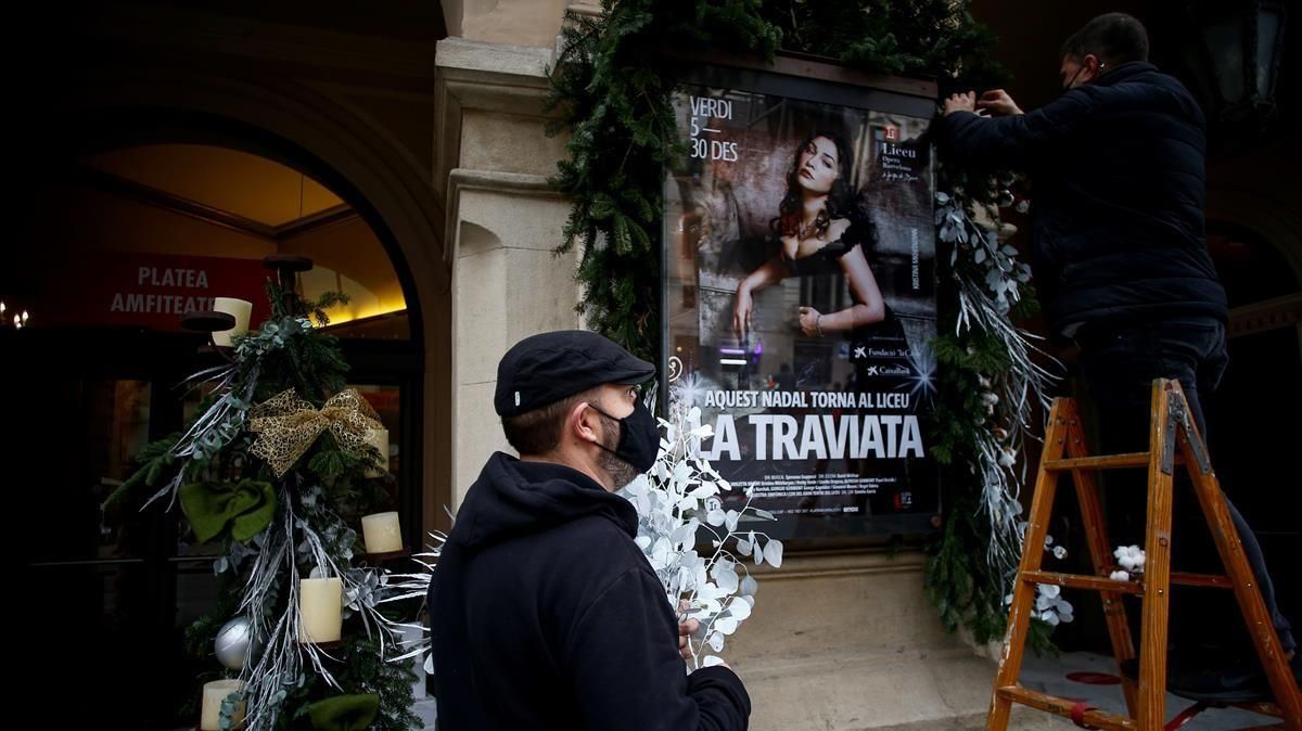 Dos trabajadores decoran el cartel de ’La Traviata’ en la entrada principal del Gran Teatre del Liceu esta semana. Dos trabajadores decoran el cartel de ’La Traviata’ en la entrada principal del Gran Teatre del Liceu esta semana.