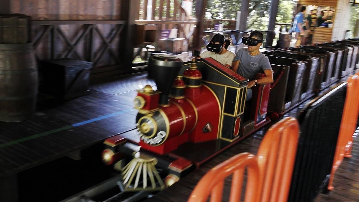 Dos pasajeros del Virtual Express, este sábado en el parque del Tibidabo. Dos pasajeros del Virtual Express, este sábado en el parque del Tibidabo.