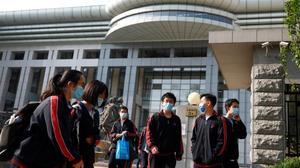 undefined53243418 students wearing face masks leave a school in beijing  china200427103205