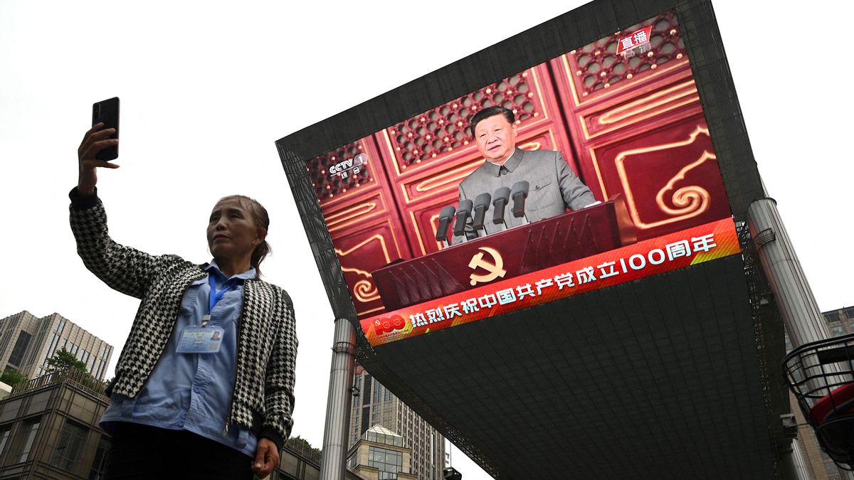 Una mujer se hace un ’selfie’ con la alocución del presidente chino Xi Jinping de fondo. Una mujer se hace un ’selfie’ con la alocución del presidente chino Xi Jinping de fondo.