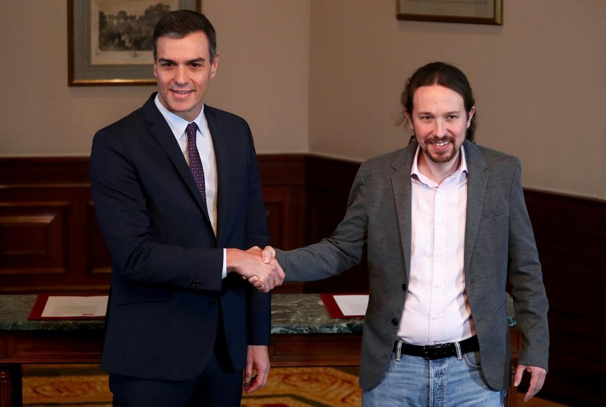 Spanish acting Prime Minister Pedro Sanchez and Unidas Podemos (Together We Can) leader Pablo Iglesias shake hands during a news conference at Spain’s Parliament in Madrid, Spain, November 12, 2019. REUTERS/Sergio Perez
