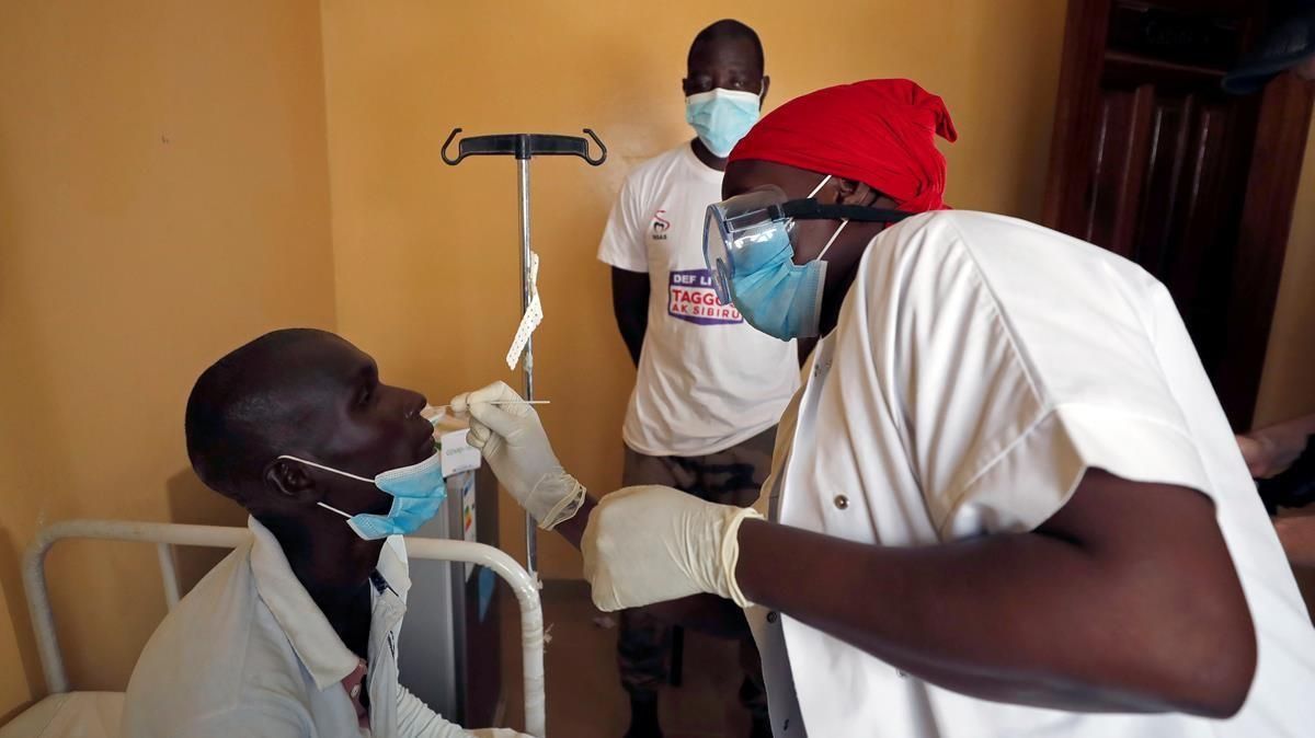 A health worker takes a swab sample from a man for a rapid antigen test as hundreds of thousands of Senegalese Mouride Brotherhood pilgrims gather for the annual Grand Magal festival as the global spread of the coronavirus disease (COVID-19) continues in the holy city of Touba Senegal October 5 2020 Picture taken October 5 2020 REUTERS Zohra Bensemra A health worker takes a swab sample from a man for a rapid antigen test as hundreds of thousands of Senegalese Mouride Brotherhood pilgrims gather for the annual Grand Magal festival as the global spread of the coronavirus disease (COVID-19) continues in the holy city of Touba Senegal October 5 2020 Picture taken October 5 2020 REUTERS Zohra Bensemra