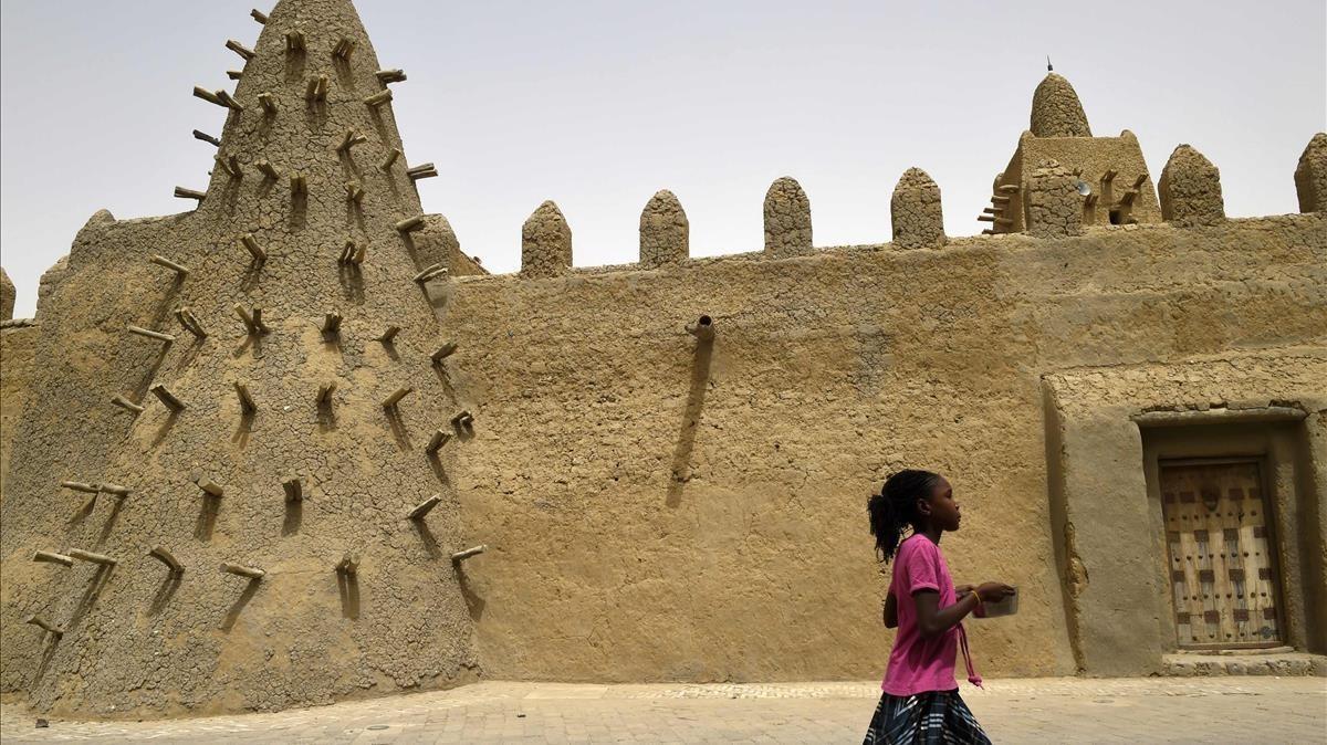 Una niña pasa por la mezquita Djingareyber en Tombuctú, en Malí, en junio del 2015, durante una operación antiterrorista del ejército francés en el Sahel. Una niña pasa por la mezquita Djingareyber en Tombuctú, en Malí, en junio del 2015, durante una operación antiterrorista del ejército francés en el Sahel.