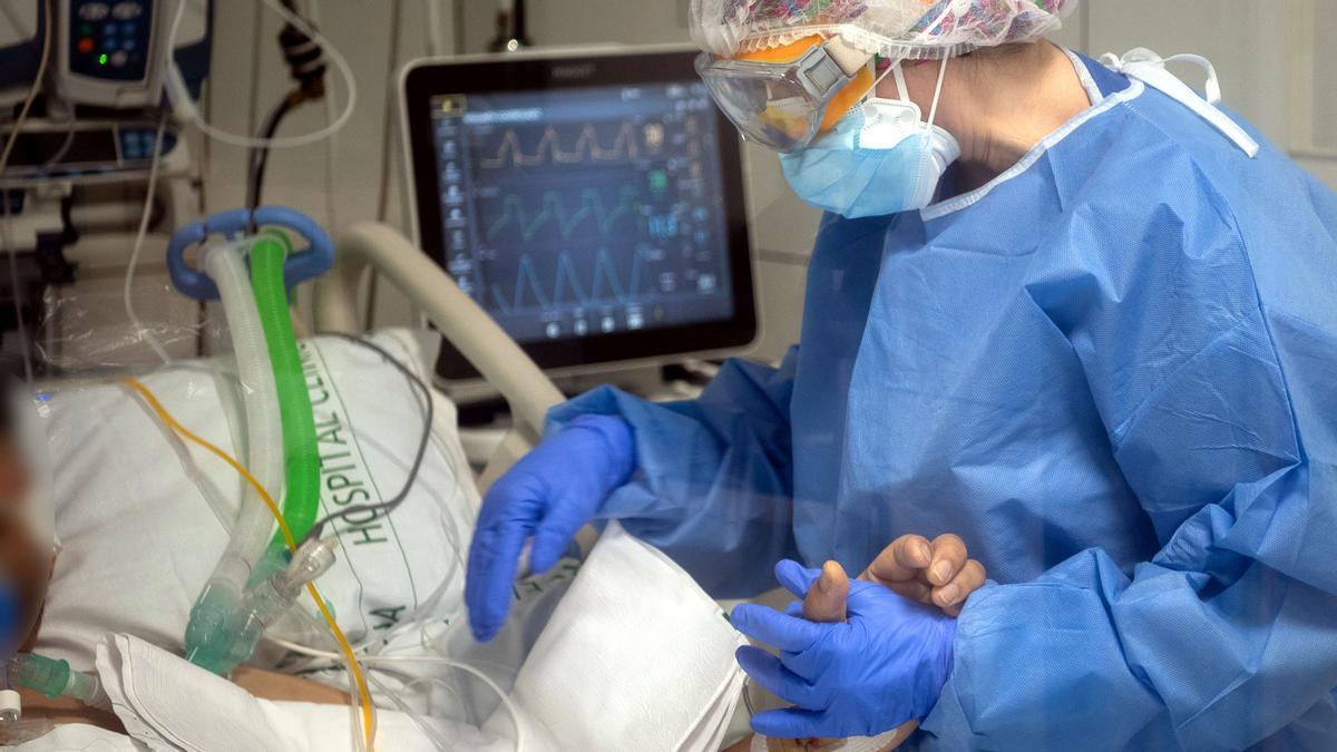 Una enfermera anima a un paciente ingresado en la UCI del Hospital Clínic de Barcelona.
