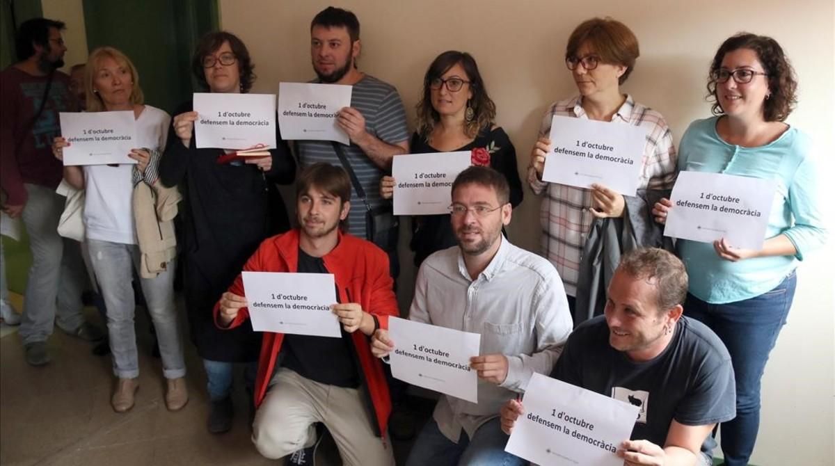 Diputados de la CUP y de Podem en Barberà del Vallès con carteles a favor de la democracia y del referéndum. Diputados de la CUP y de Podem en Barberà del Vallès con carteles a favor de la democracia y del referéndum.