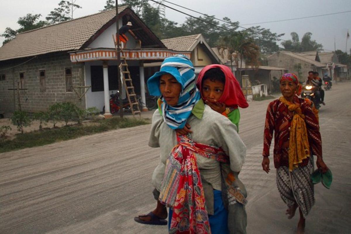 Varios vecinos se dirigen a un centro de evacuación en Kediri, al este de Java, este viernes.