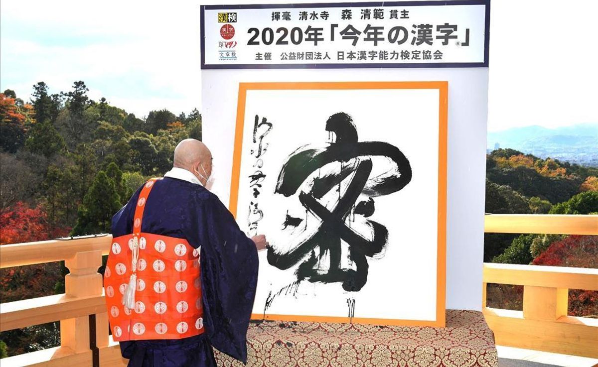 This picture received from Jiji Press shows Seihan Mori master of the ancient Kiyomizu temple using calligraphy to write the Chinese character known in Japan as kanji for mitsu which was selected as the single best kanji to symbolise the year of 2020 at the temple in Kyoto western Japan on December 14 2020 (Photo by STR JAPAN POOL AFP) Japan OUT This picture received from Jiji Press shows Seihan Mori master of the ancient Kiyomizu temple using calligraphy to write the Chinese character known in Japan as kanji for mitsu which was selected as the single best kanji to symbolise the year of 2020 at the temple in Kyoto western Japan on December 14 2020 (Photo by STR JAPAN POOL AFP) Japan OUT