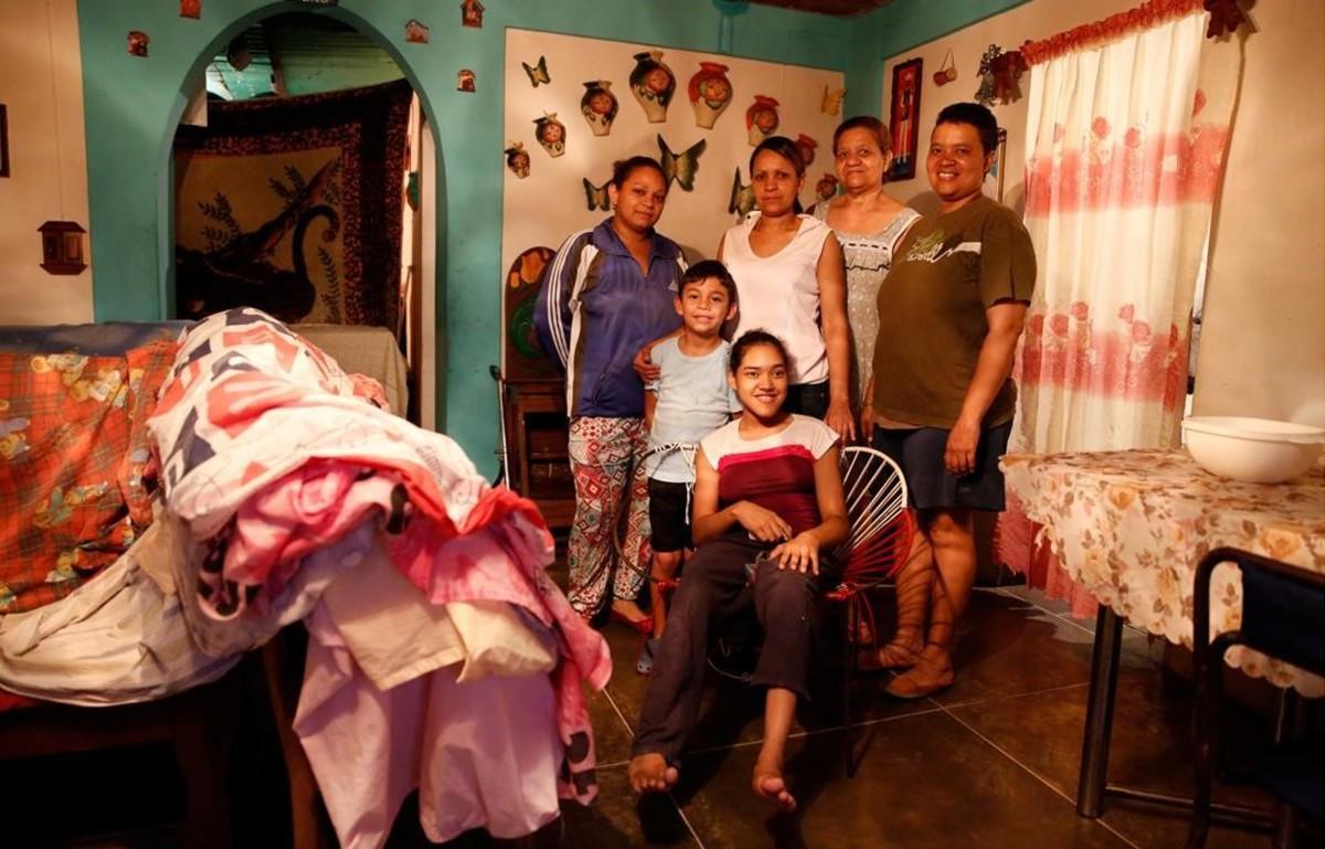 La familia de Victoria Mata, segunda por la derecha, cuenta en su casa de Caracas que se han visto obligados a comer menos por la carestía de los alimentos.