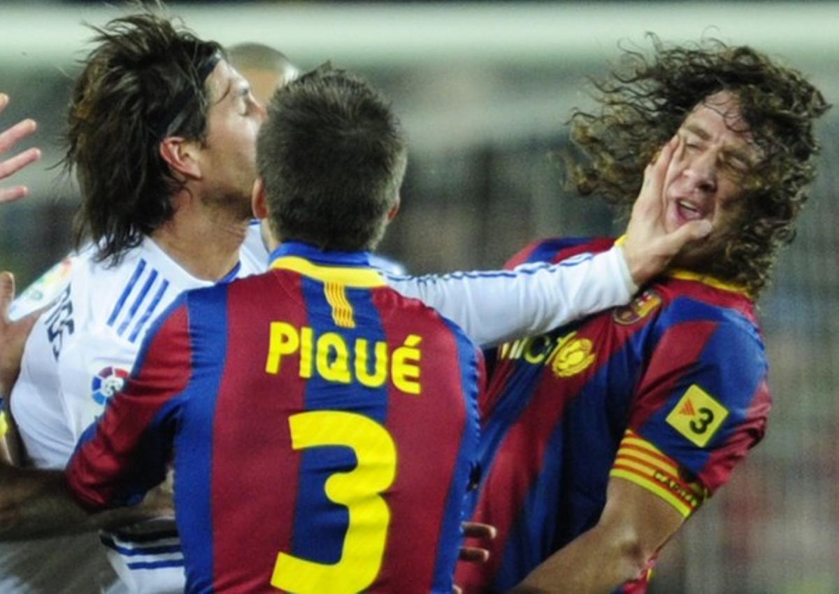 Ramos da un manotazo a Puyol cuando este iba a recriminarle su entrada a Messi durante el clásico Barça-Real Madrid.