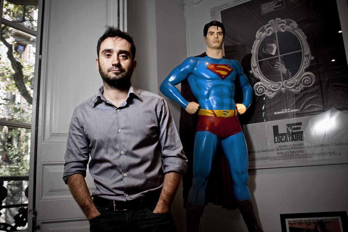 J. A. Bayona junto a una imagen de Supermán, un héroe habitual en sus vídeos musicales. 