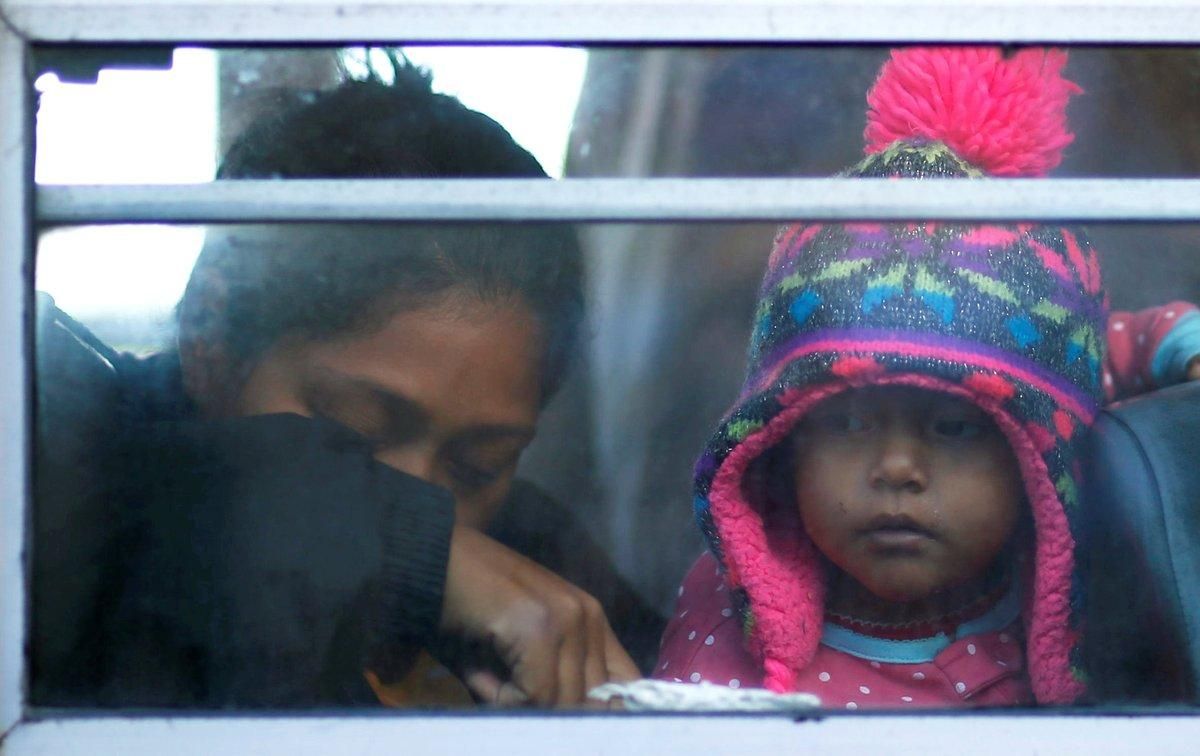 Migrants woman and her daughter part of a caravan of thousands from Central America trying to reach the United States sit in a bus after leaving a camp as they feel insecure in Tijuana Mexico REUTERS Mohammed Salem Migrants woman and her daughter part of a caravan of thousands from Central America trying to reach the United States sit in a bus after leaving a camp as they feel insecure in Tijuana Mexico REUTERS Mohammed Salem