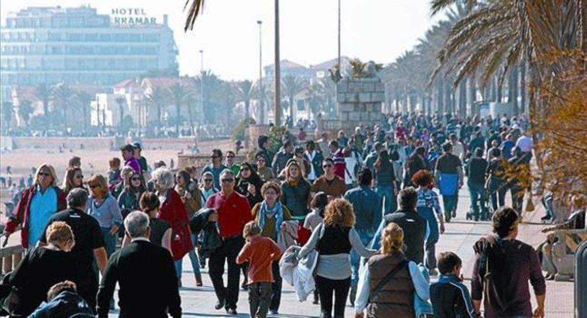 El paseo marítimo y la playa de Sitges, ayer, abarrotados de domingueros. El paseo marítimo y la playa de Sitges, ayer, abarrotados de domingueros.