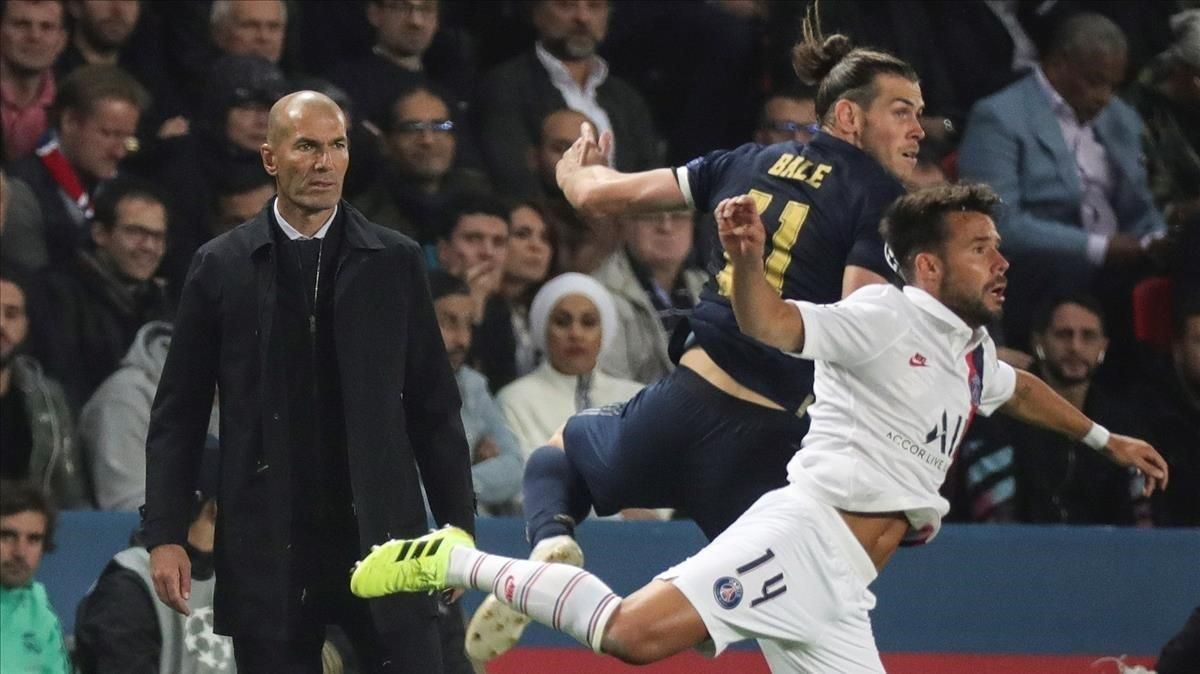 Zidane (derecha) mira una acción del partido entre el Madrid y el PSG protagonizada por Bale y Bernat. Zidane (derecha) mira una acción del partido entre el Madrid y el PSG protagonizada por Bale y Bernat.
