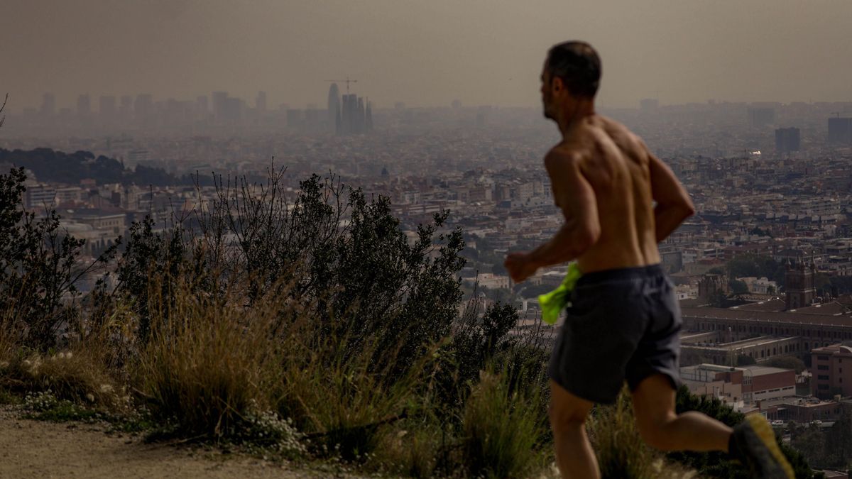 Un corredor en la carretera de las Aigües, con la calima sobre el cielo de Barcelona, este viernes Un corredor en la carretera de las Aigües, con la calima sobre el cielo de Barcelona, este viernes