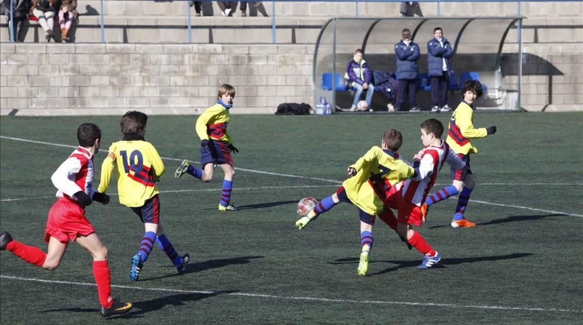 Niños jugando a fútbol en el campo del CF Alzamora, en el barrio de Porta de Barcelona. Niños jugando a fútbol en el campo del CF Alzamora, en el barrio de Porta de Barcelona.