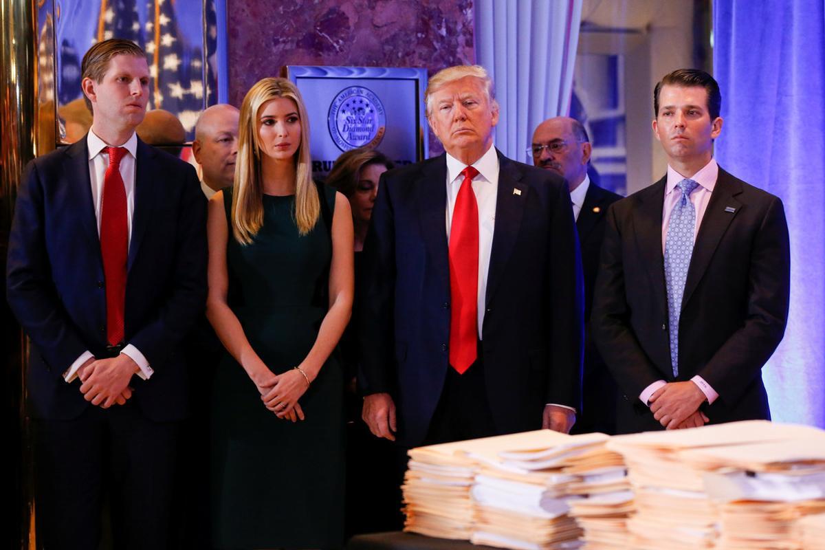 REFILE - CORRECTING ID FOR PERSON ON THE RIGHT.   U.S. President-elect Donald Trump (C) stands surrounded by his son Eric Trump (L) daughter Ivanka and son Donald Trump Jr. (R) ahead of a press conference in Trump Tower, Manhattan, New York, U.S., January 11, 2017. REUTERS/Shannon Stapleton     TPX IMAGES OF THE DAY