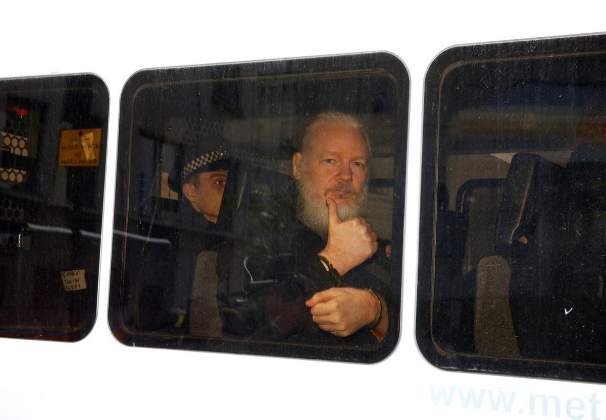 FILE PHOTO  WikiLeaks founder Julian Assange is seen in a police van after was arrested by British police outside the Ecuadorian embassy in London  Britain April 11  2019  REUTERS Henry Nicholls File Photo