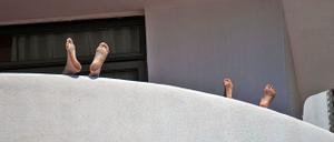 Dos estudiantes alojados en el hotel Palma Bellver del paseo Marítimo se relajan en la terraza de su habitación.