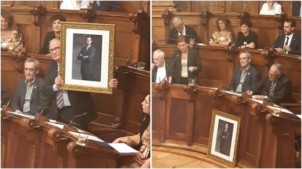 Bou esgrime el retrato del Rey, que luego ha dejado delante de su asiento, durante el pleno municipal de este lunes. Bou esgrime el retrato del Rey, que luego ha dejado delante de su asiento, durante el pleno municipal de este lunes.