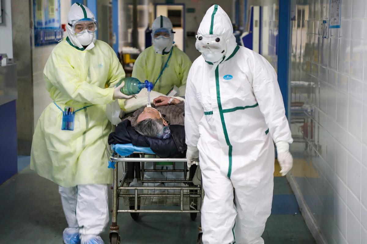 Medical workers in protective suits move a patient at an isolated ward of a hospital in Caidian district following an outbreak of the novel coronavirus in Wuhan, Hubei province, China February 6, 2020. Picture taken February 6, 2020. China Daily via REUTERS  ATTENTION EDITORS - THIS IMAGE WAS PROVIDED BY A THIRD PARTY. CHINA OUT.