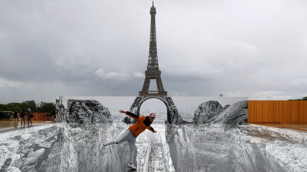 A giant artwork by French artist JR installed in front of the Eiffel Tower in Paris A giant artwork by French artist JR installed in front of the Eiffel Tower in Paris