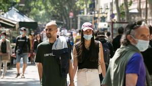 Gente con y sin mascarilla, por la Rambla de Barcelona.