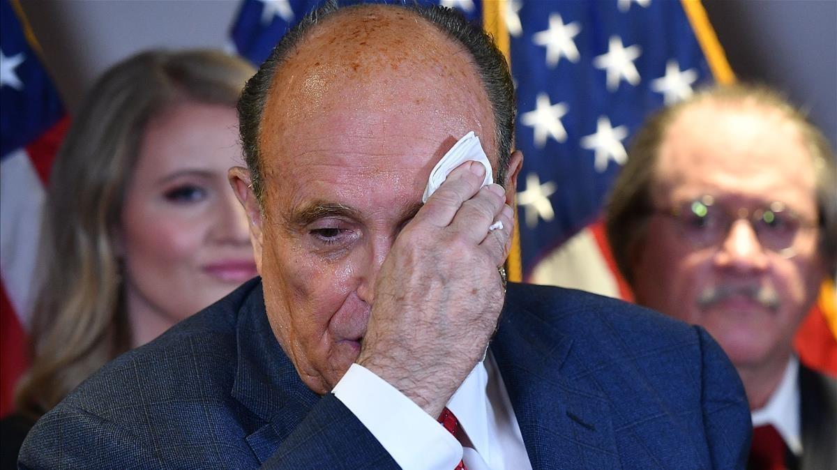 (FILES) In this file photo taken on November 19  2020 Trump s personal lawyer Rudy Giuliani speaks during a press conference at the Republican National Committee headquarters in Washington  DC  - US president Donald Trump announces on December 6  2020 his lawyer Giuliani tests positive for Covid-19  (Photo by MANDEL NGAN   AFP)