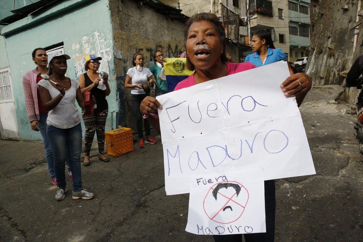 A woman with toothpaste under her nose to help with the effects of tear gas fired by security forces holds a sign that reads in Spanish Get out Maduro referring to Venezuelan President Nicolas Maduro in the Cotiza neighborhood of Caracas Security forces have fired tear gas against protesters in a poor neighborhood near the presidential palace after an apparent uprising by a national guard unit AP Photo Ariana Cubillos A woman with toothpaste under her nose to help with the effects of tear gas fired by security forces holds a sign that reads in Spanish Get out Maduro referring to Venezuelan President Nicolas Maduro in the Cotiza neighborhood of Caracas Security forces have fired tear gas against protesters in a poor neighborhood near the presidential palace after an apparent uprising by a national guard unit AP Photo Ariana Cubillos