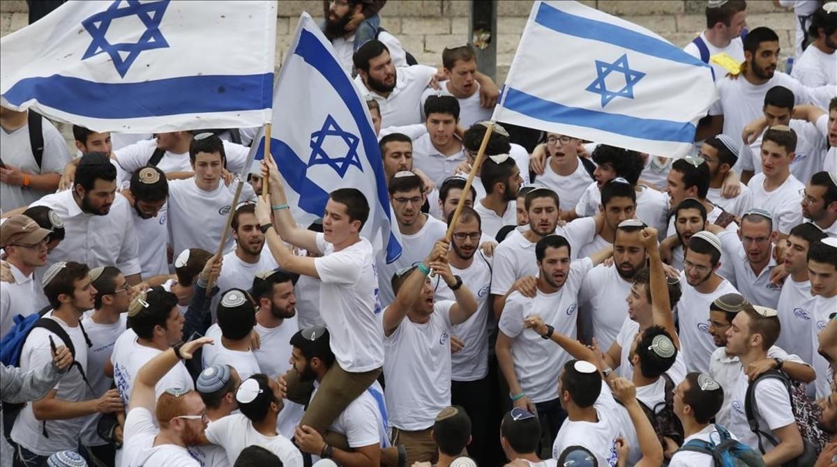 Manifestantes israelís celebran la aprobación de la ley en el Parlamento. Manifestantes israelís celebran la aprobación de la ley en el Parlamento.